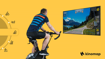 Ein Tablet auf einem Wenoker JC318 Heimtrainer zeigt während eines aktiven Home-Workouts die virtuelle Cycling-Oberfläche von Kinomap
